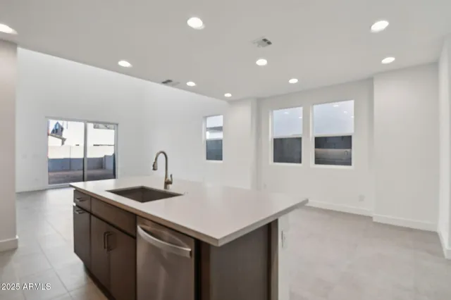 a kitchen that has a sink and a stove in it