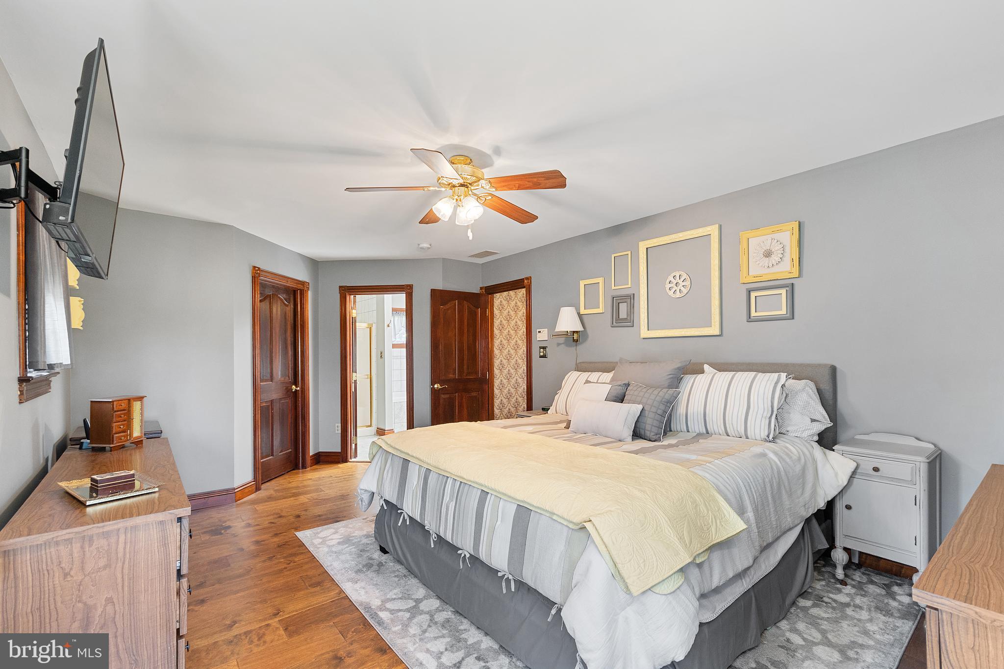487 Radix Road Williamstown, NJ 08094 - Photo 18 of 36 a bedroom with a large bed and a chandelier