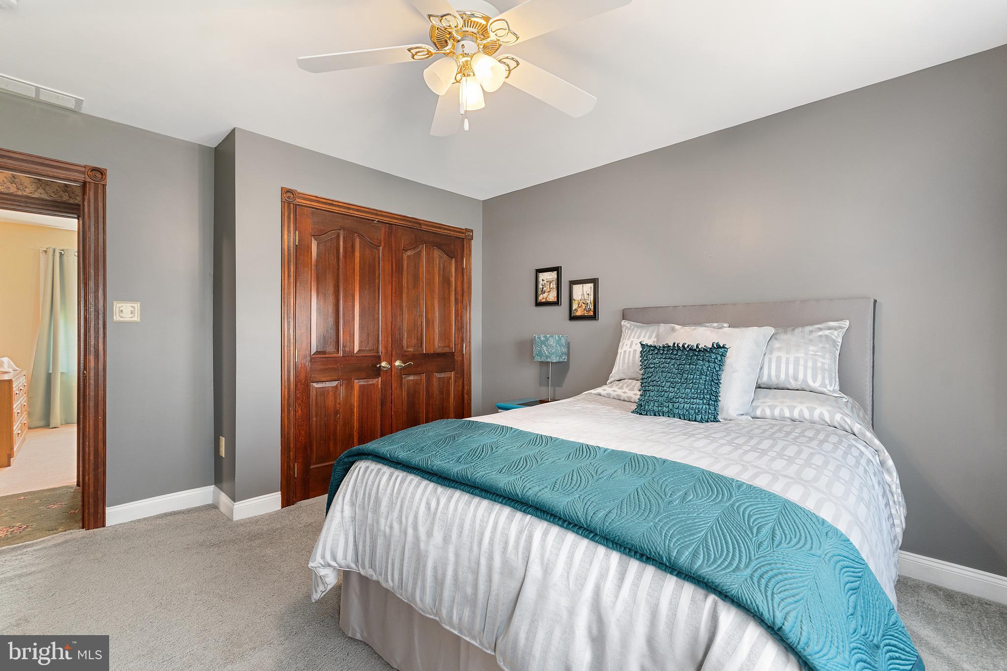 487 Radix Road Williamstown, NJ 08094 - Photo 23 of 36 a bedroom with a bed and a chandelier