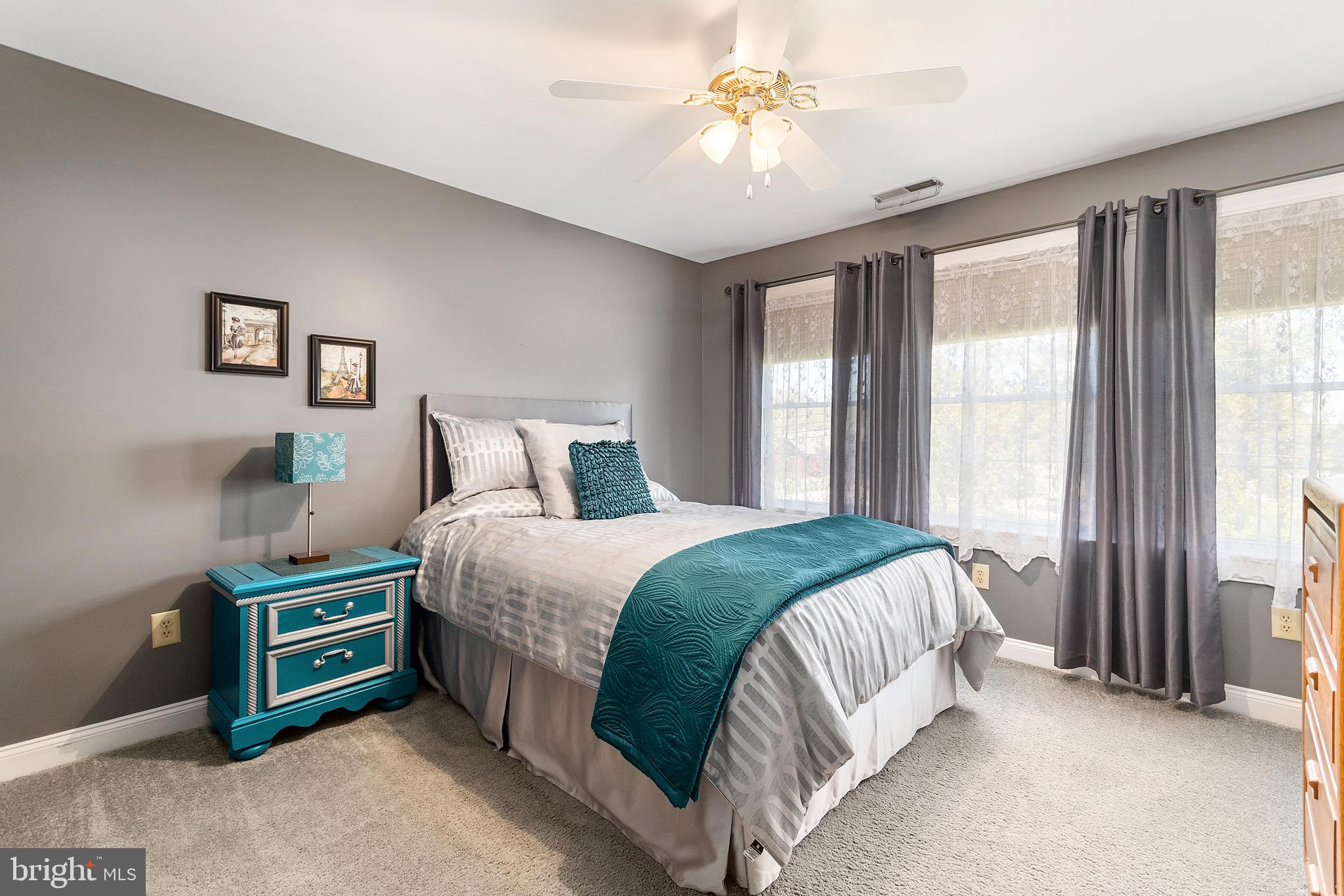 487 Radix Road Williamstown, NJ 08094 - Photo 24 of 36 a bedroom with a bed and a chandelier