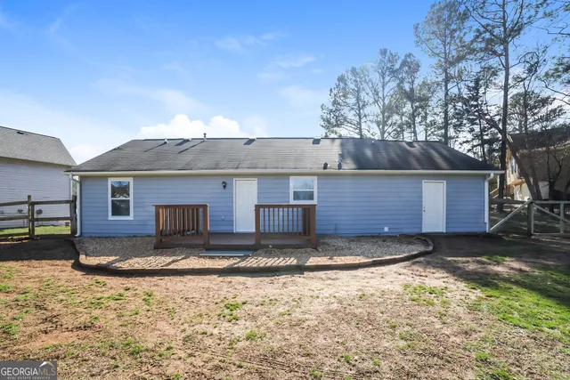 a view of a house with a yard covered in snow