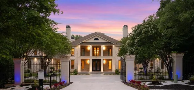 a front view of a house with a tree