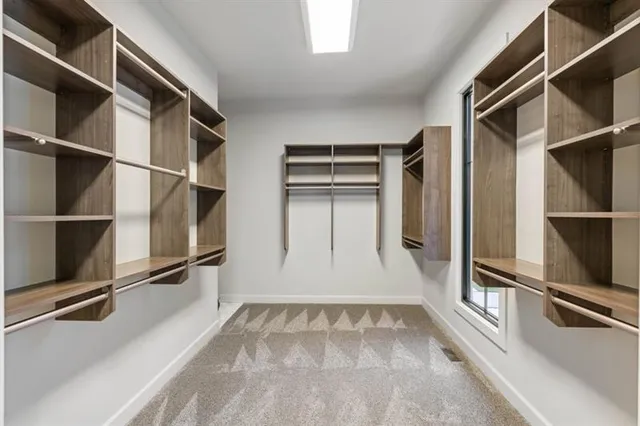 a spacious bedroom with a large bed and a window