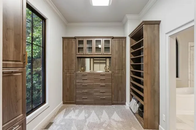 a bathroom with a double vanity sink a toilet a mirror and shower