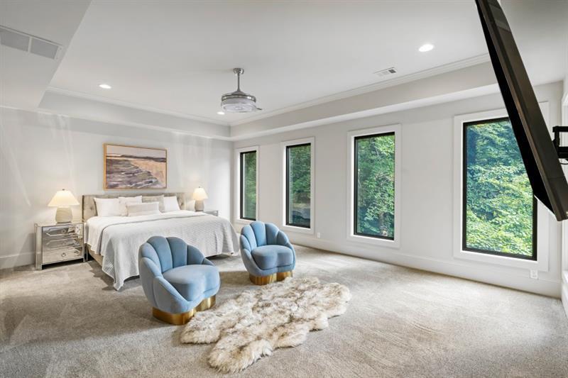 1430 North Harris Ridge Northwest Atlanta, GA 30327 - Photo 28 of 60 a spacious bedroom with a large bed and a window
