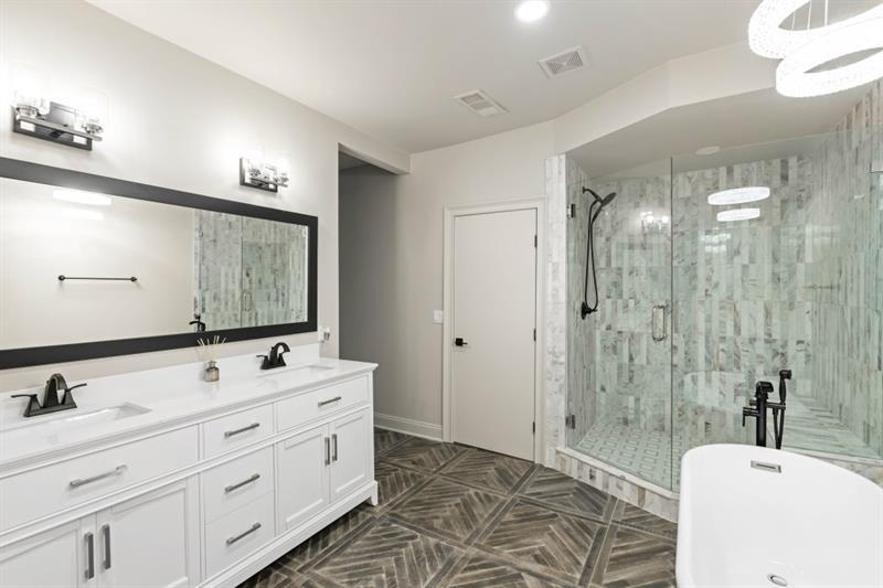 1430 North Harris Ridge Northwest Atlanta, GA 30327 - Photo 29 of 60 a bathroom with a double vanity sink a toilet a mirror and shower