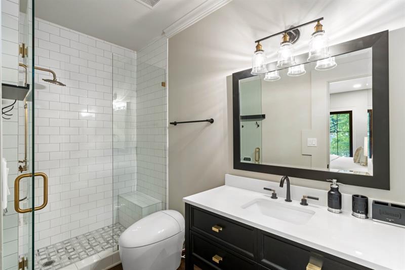 1430 North Harris Ridge Northwest Atlanta, GA 30327 - Photo 31 of 60 a bathroom with a sink a toilet and shower