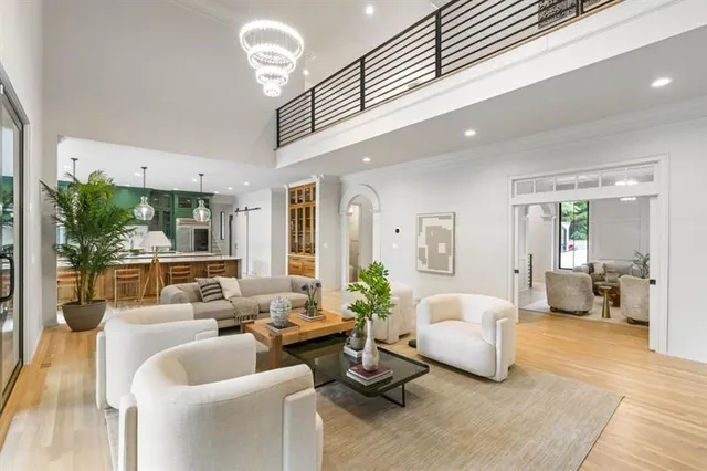 a living room with furniture and a chandelier