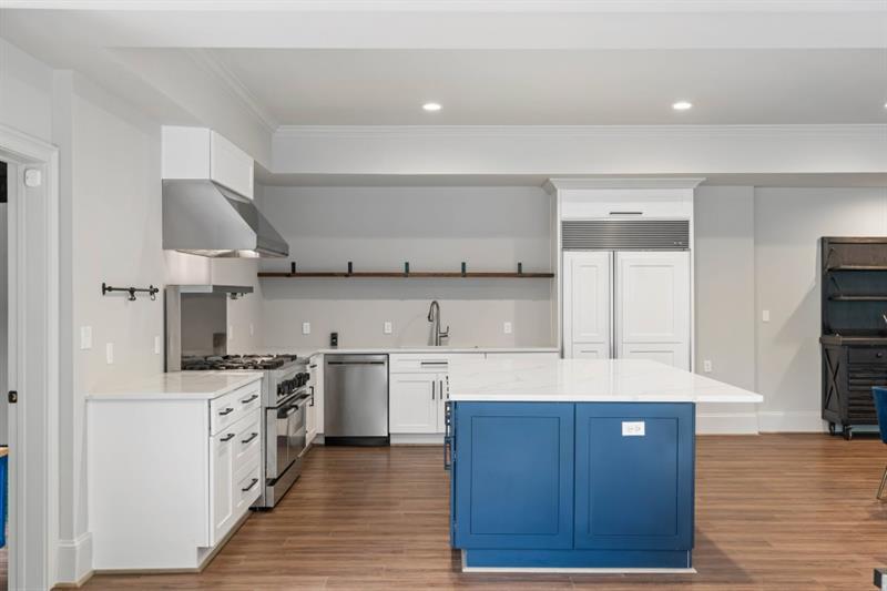 1430 North Harris Ridge Northwest Atlanta, GA 30327 - Photo 43 of 60 a kitchen with stainless steel appliances a sink stove and cabinets