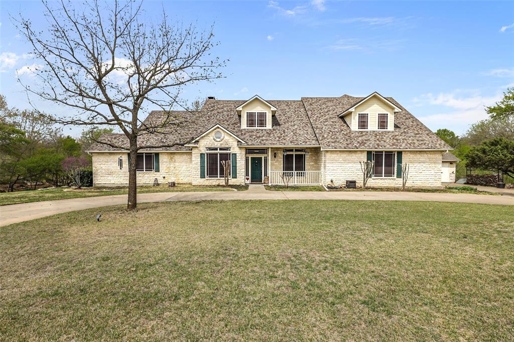 3558 South Nolan River Road Cleburne, TX 76033 - Photo 1 of 1 a front view of a house with a garden