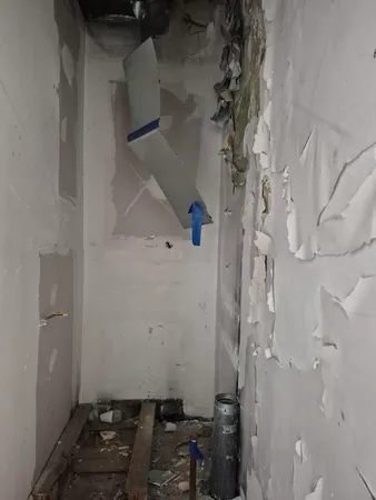 a room with water heater and wooden floor