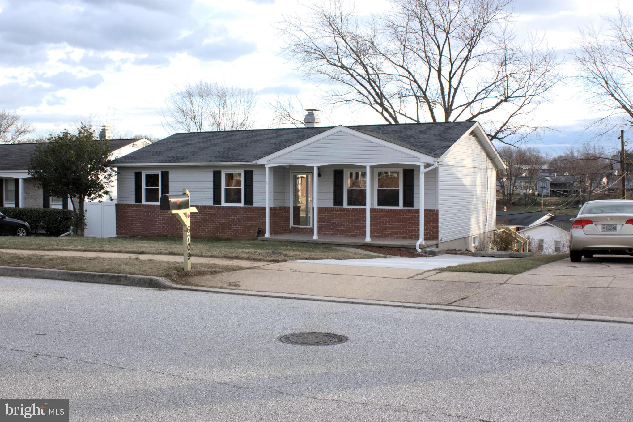 6709 Garvey Road Baltimore, MD 21237 - Photo 1 of 29 a front view of a house with a yard and garage
