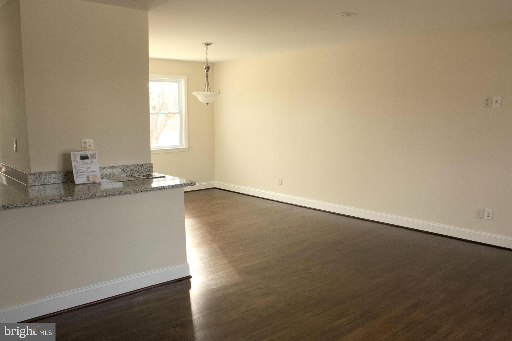6709 Garvey Road Baltimore, MD 21237 - Photo 2 of 29 an empty room with wooden floor and windows