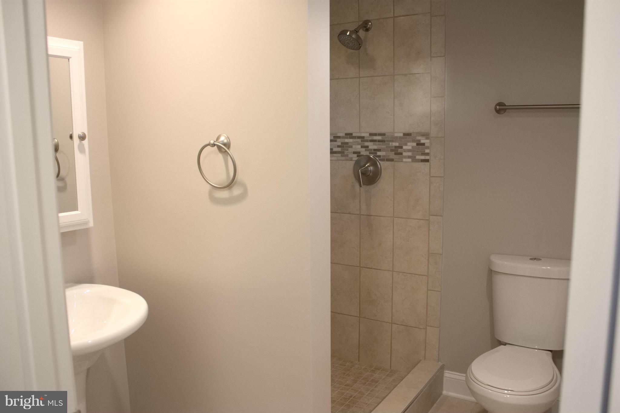 6709 Garvey Road Baltimore, MD 21237 - Photo 12 of 29 a bathroom with a toilet and a shower