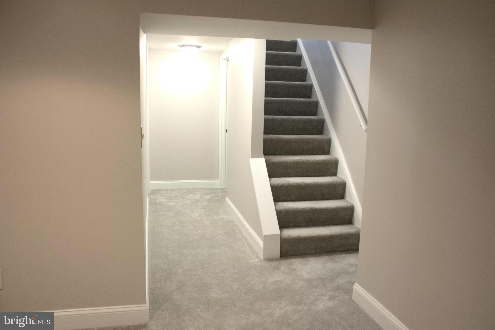 6709 Garvey Road Baltimore, MD 21237 - Photo 18 of 29 a view of staircase with empty racks