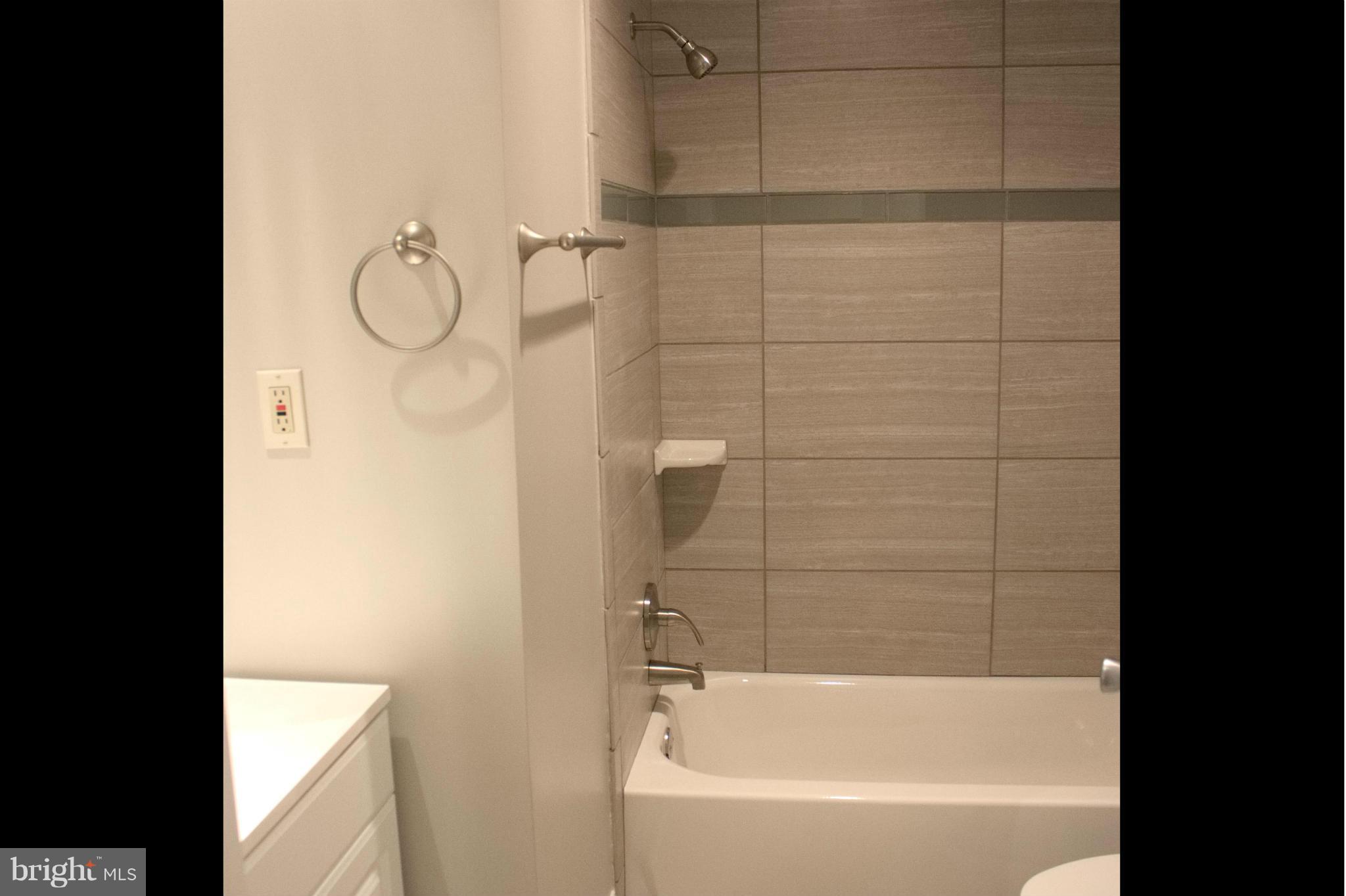 6709 Garvey Road Baltimore, MD 21237 - Photo 19 of 29 a bathroom with a shower and a bathtub