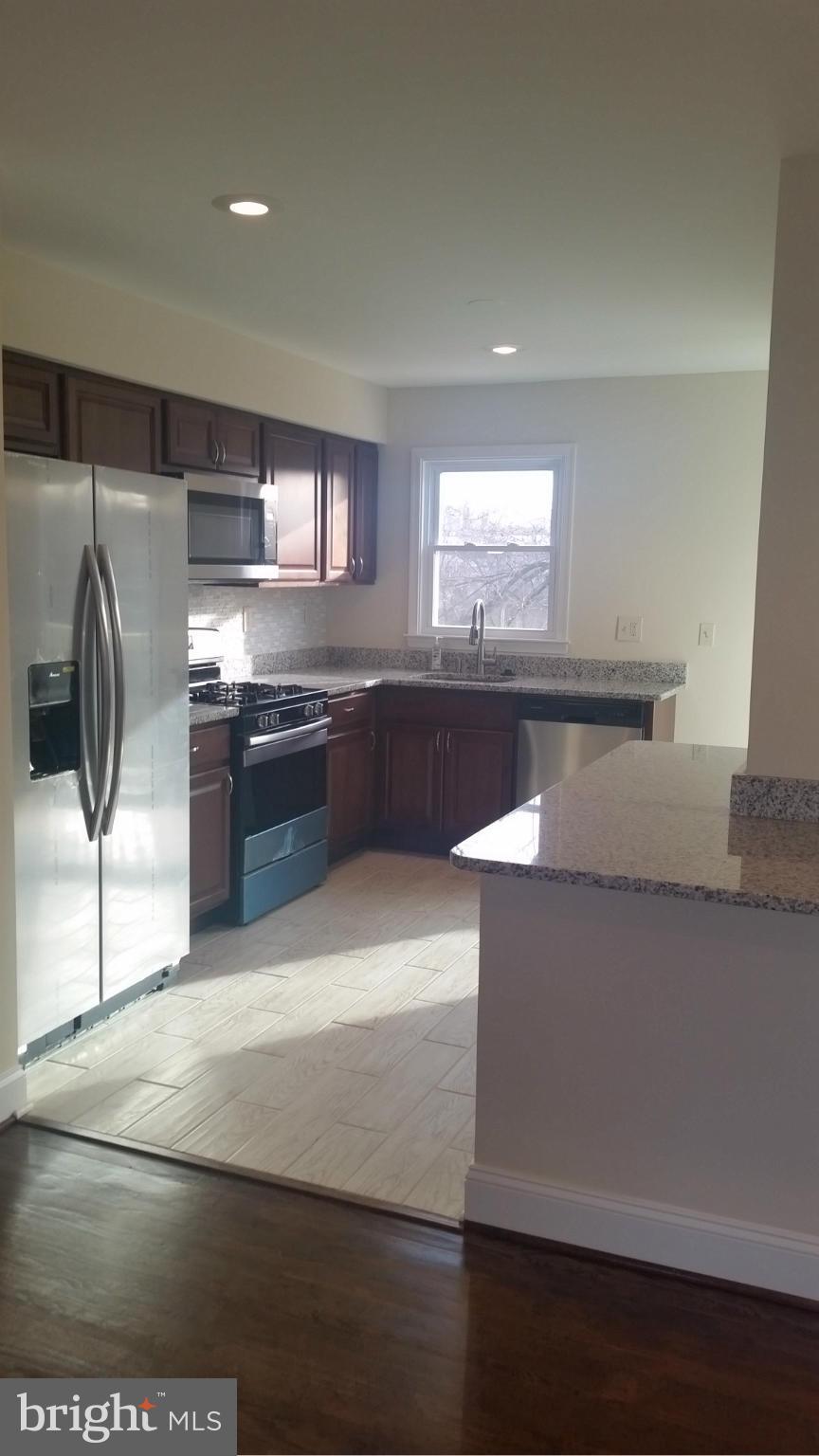 6709 Garvey Road Baltimore, MD 21237 - Photo 7 of 29 a kitchen with stainless steel appliances granite countertop a sink and a stove