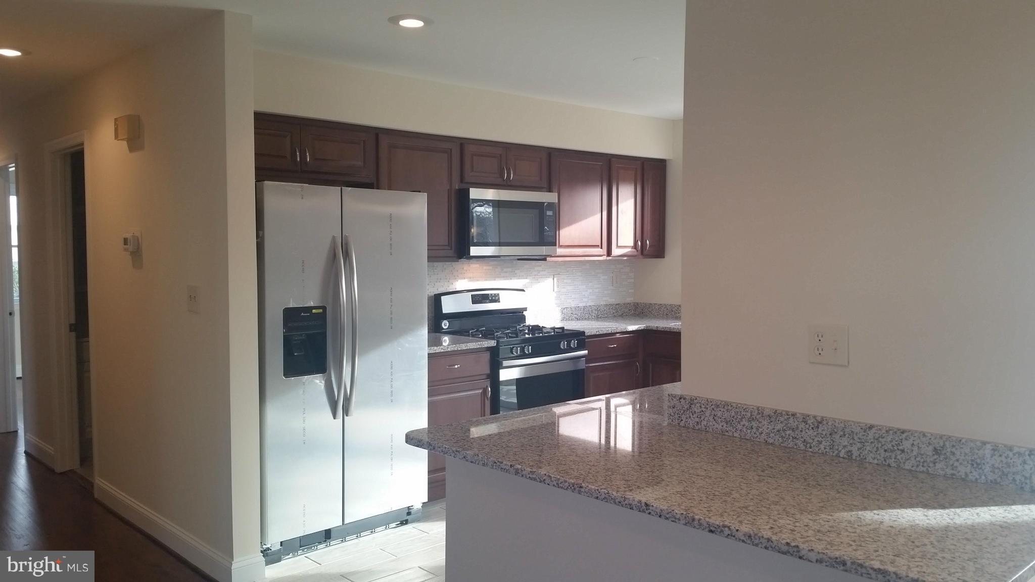 6709 Garvey Road Baltimore, MD 21237 - Photo 8 of 29 a kitchen with stainless steel appliances granite countertop a refrigerator and a sink