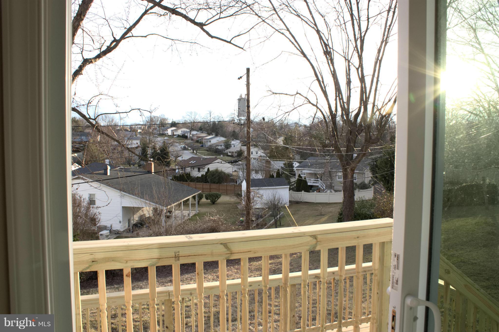 6709 Garvey Road Baltimore, MD 21237 - Photo 9 of 29 a balcony with a tree