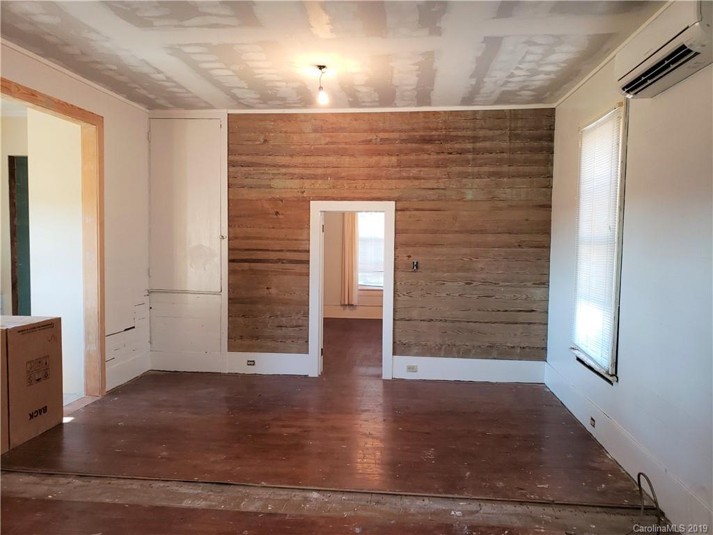 8131 Oak Tree Road Sharon, SC 29742 - Photo 13 of 36 an empty room with wooden floor and windows