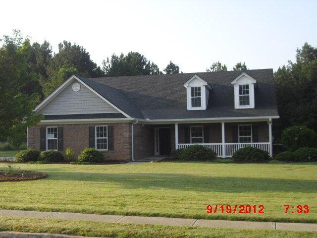 2105 Raegan Court Monroe, GA 30655 - Photo 1 of 1 a front view of a house with garden
