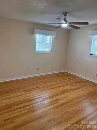 a view of a room with wooden floor