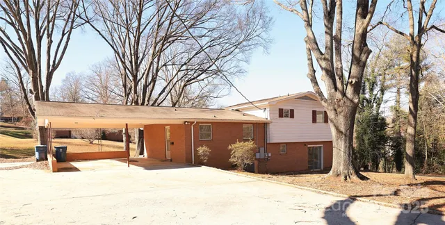 a view of a house with snow on the road