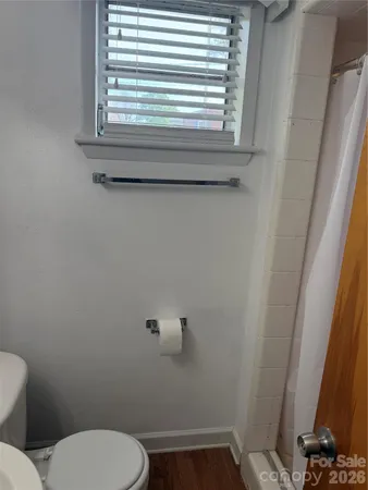 a bathroom with a toilet window and vanity