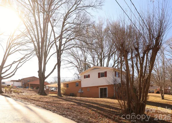 a front view of a house with trees