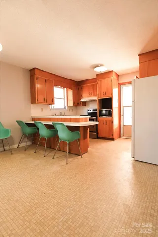 a view of a kitchen with a table and chairs