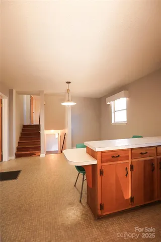 a room with stairs and a wooden floor