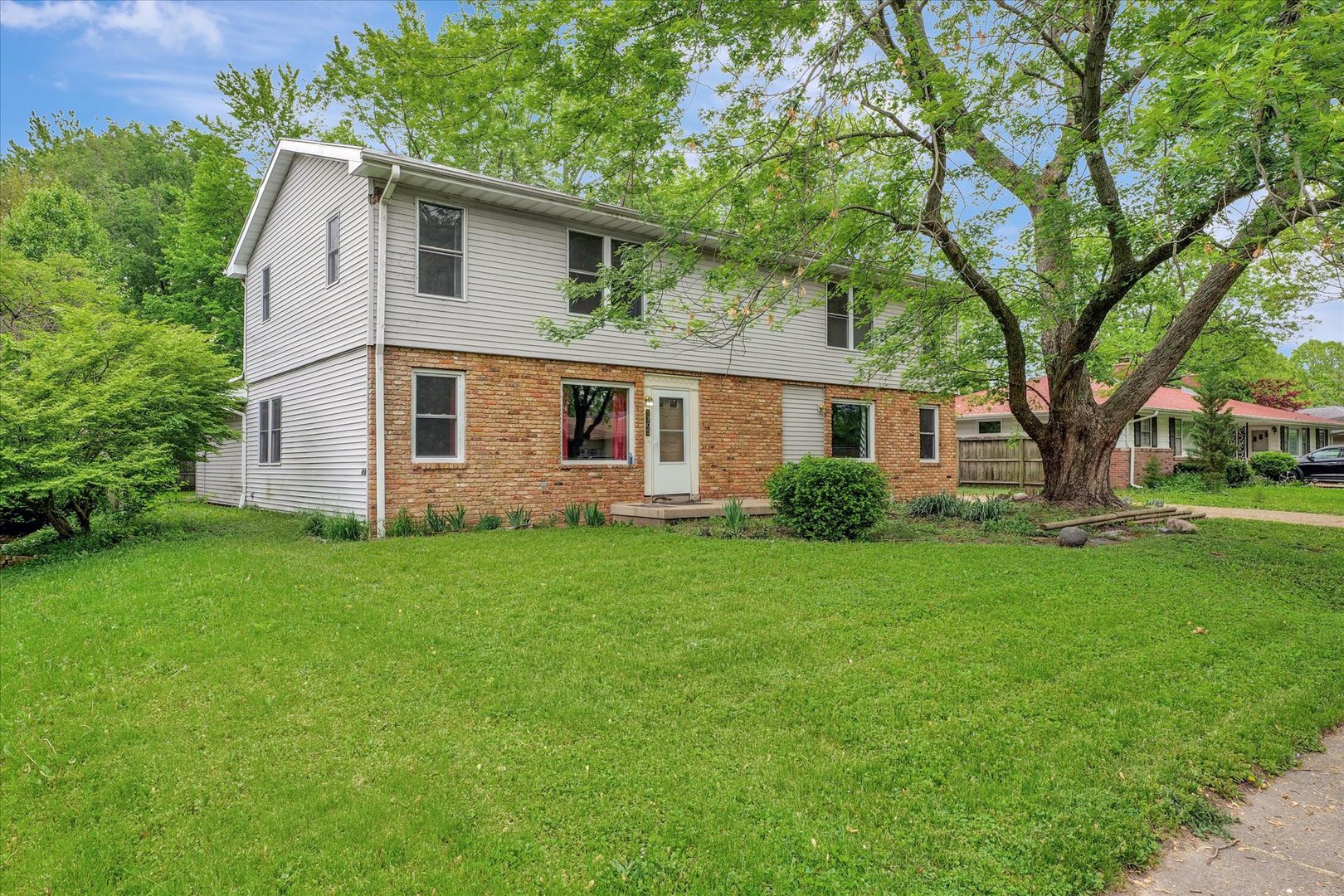 a front view of house with yard and green space
