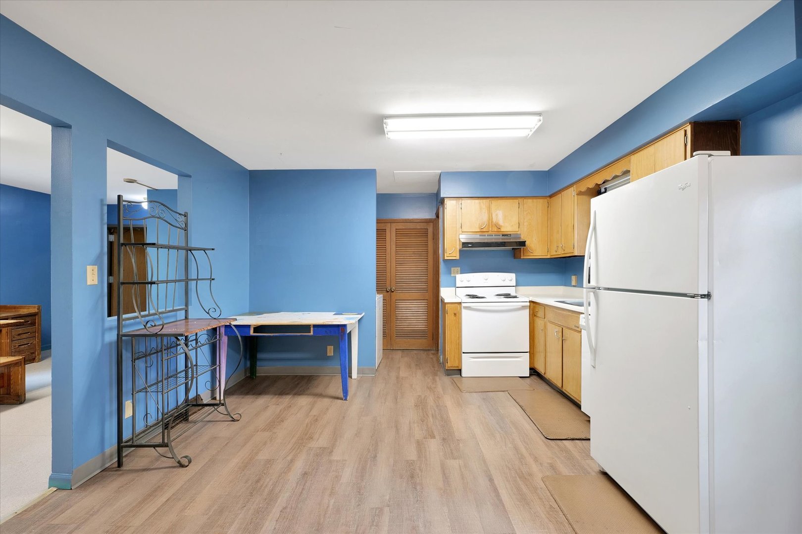1705 Georgetown Drive Champaign, IL 61821 - Photo 14 of 44 a kitchen with a refrigerator a stove and white cabinets with wooden floor