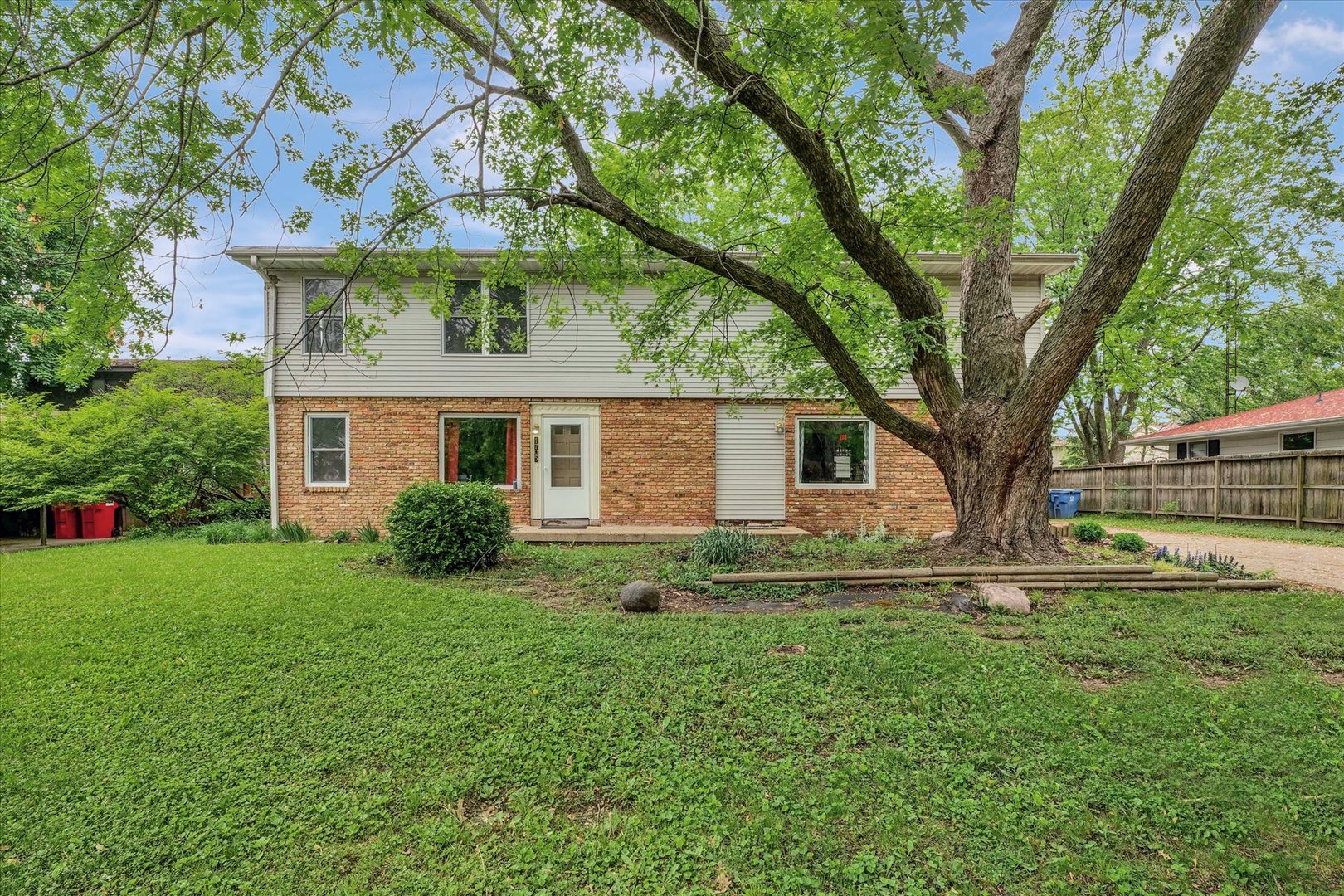 1705 Georgetown Drive Champaign, IL 61821 - Photo 2 of 44 a front view of a house with garden