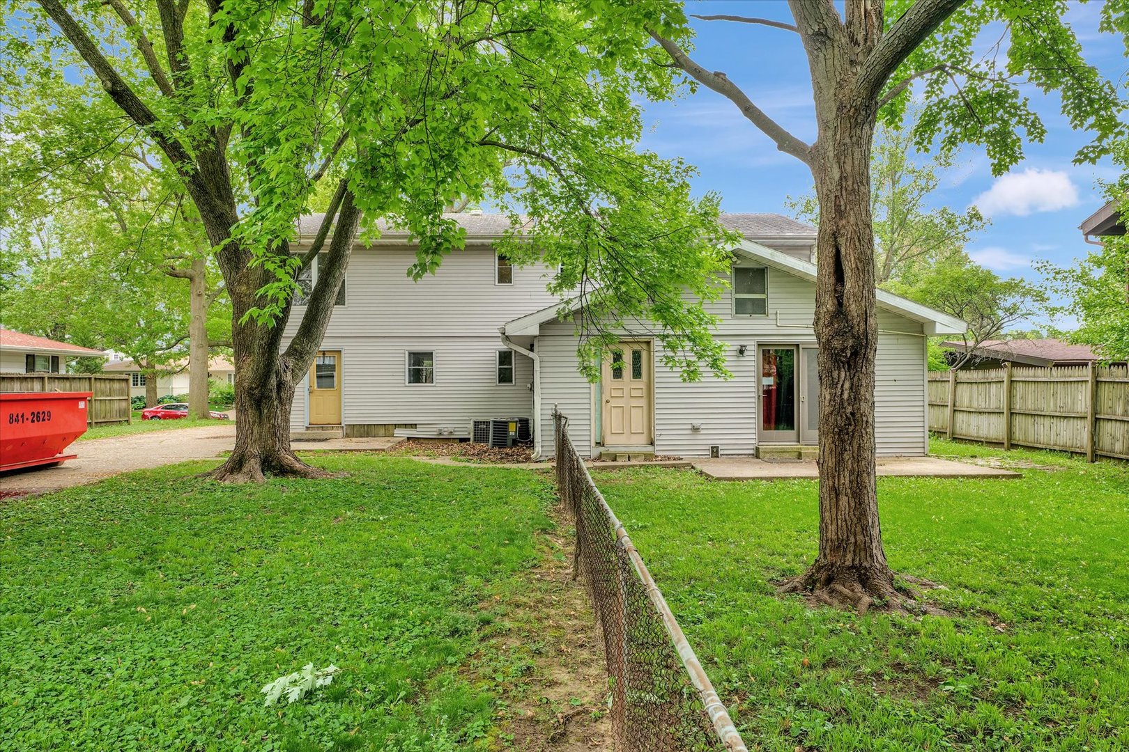 1705 Georgetown Drive Champaign, IL 61821 - Photo 40 of 44 a view of a white house next to a yard with big trees