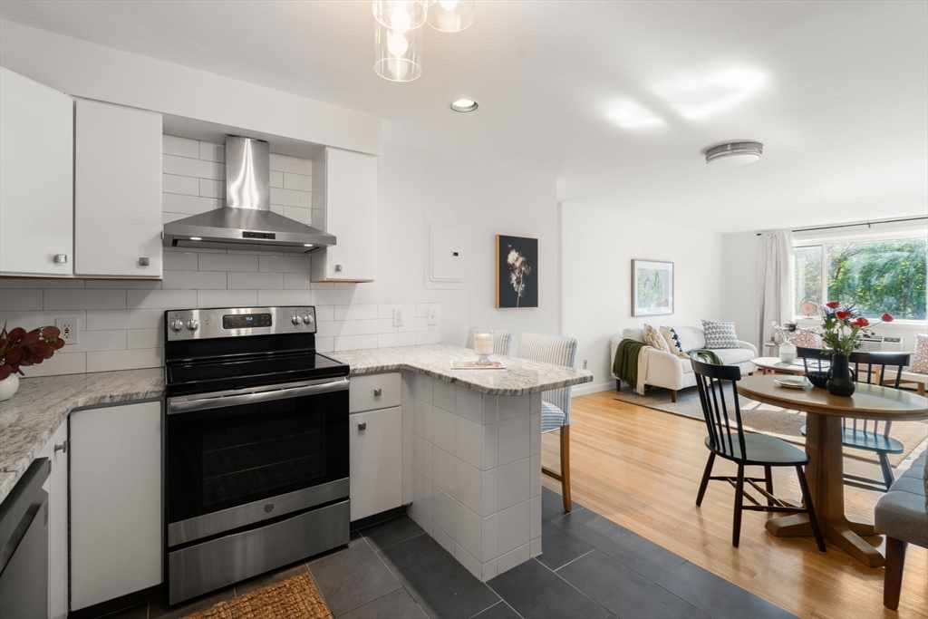 205 Kent Street, Unit 48 Brookline, MA 02446 - Photo 4 of 10 a kitchen with a stove a sink and a refrigerator