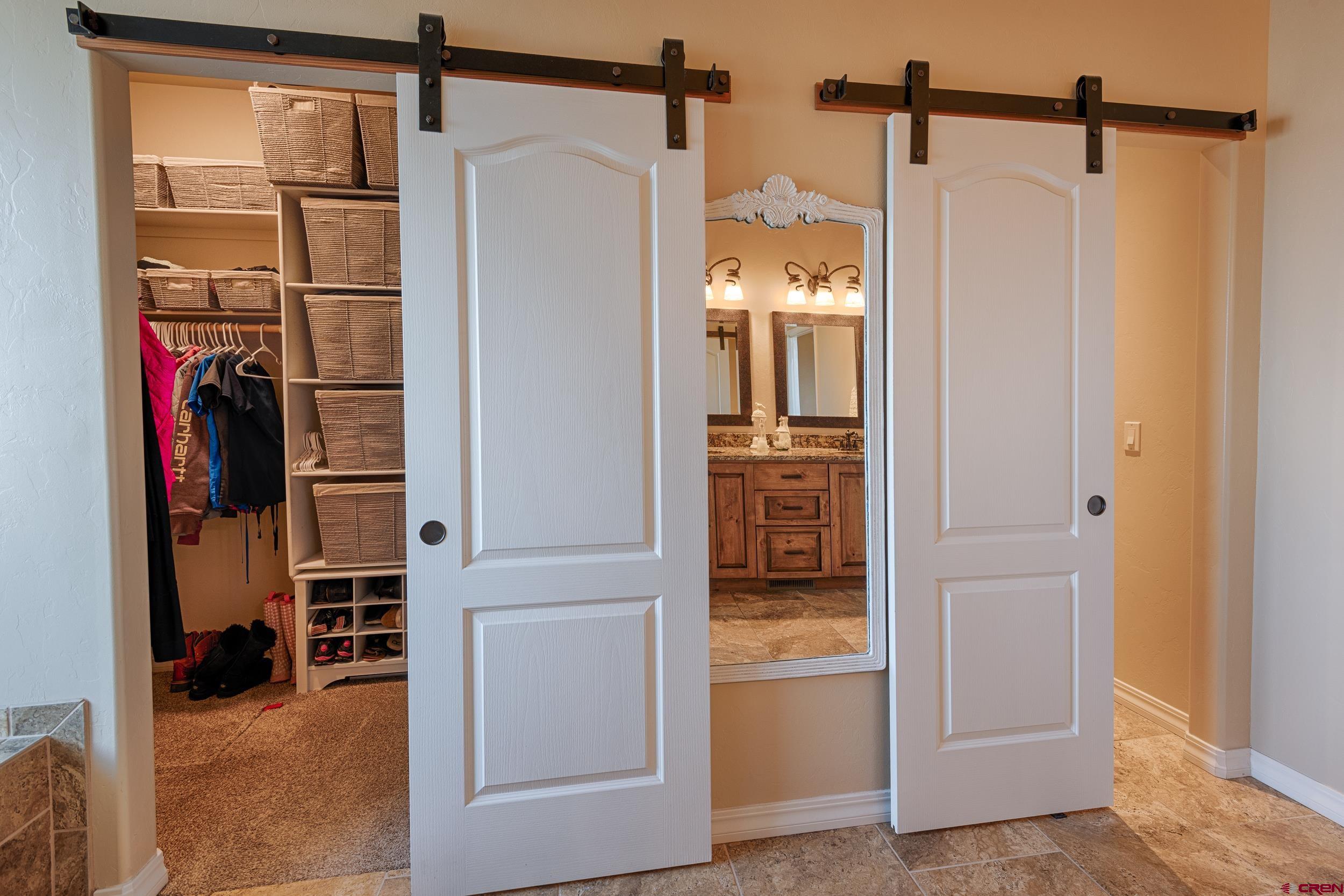 13287 6160th Road Montrose, CO 81403 - Photo 12 of 35 a view of walk in closet with clothes and shoes
