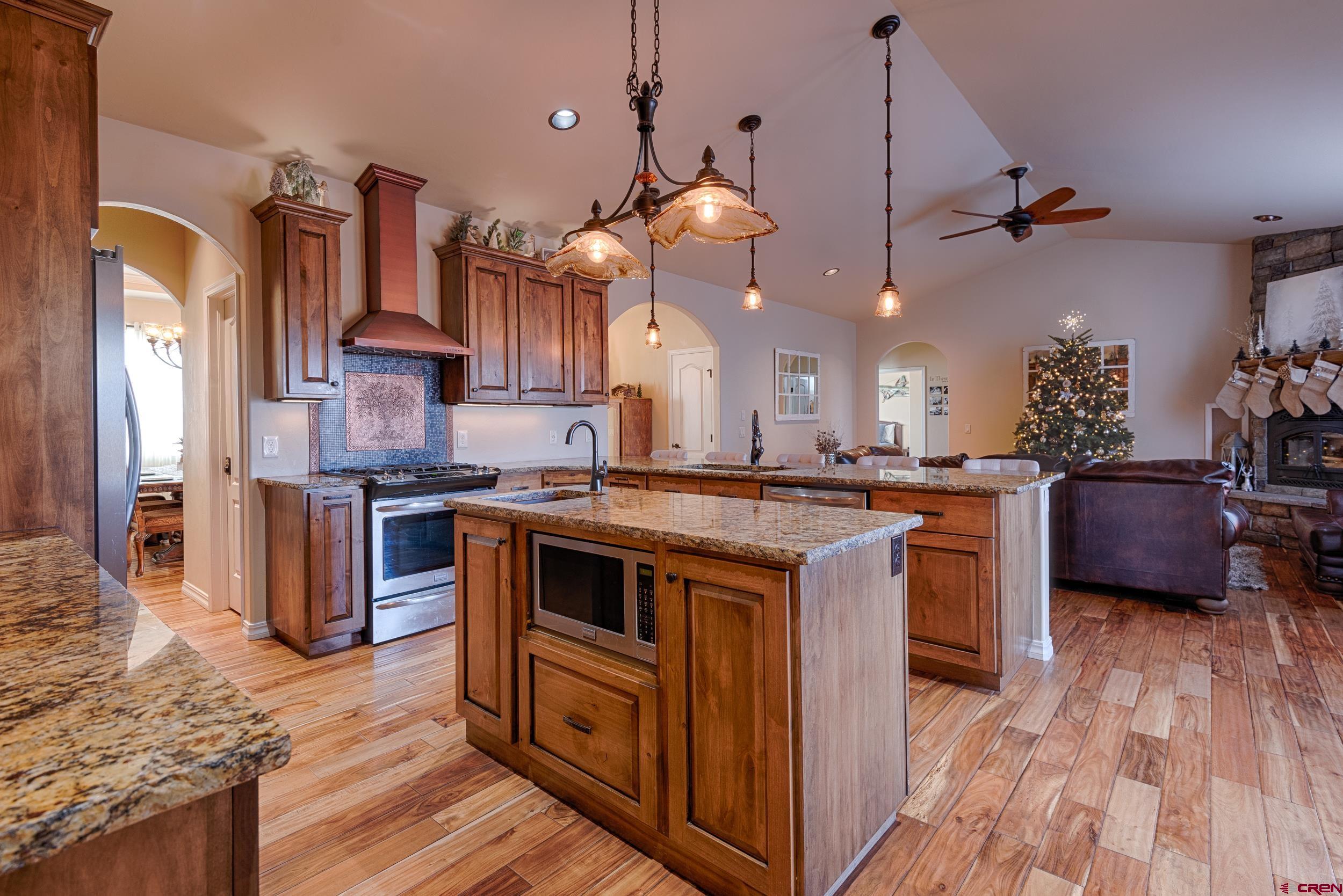 13287 6160th Road Montrose, CO 81403 - Photo 13 of 35 a kitchen with granite countertop a sink cabinets and stainless steel appliances