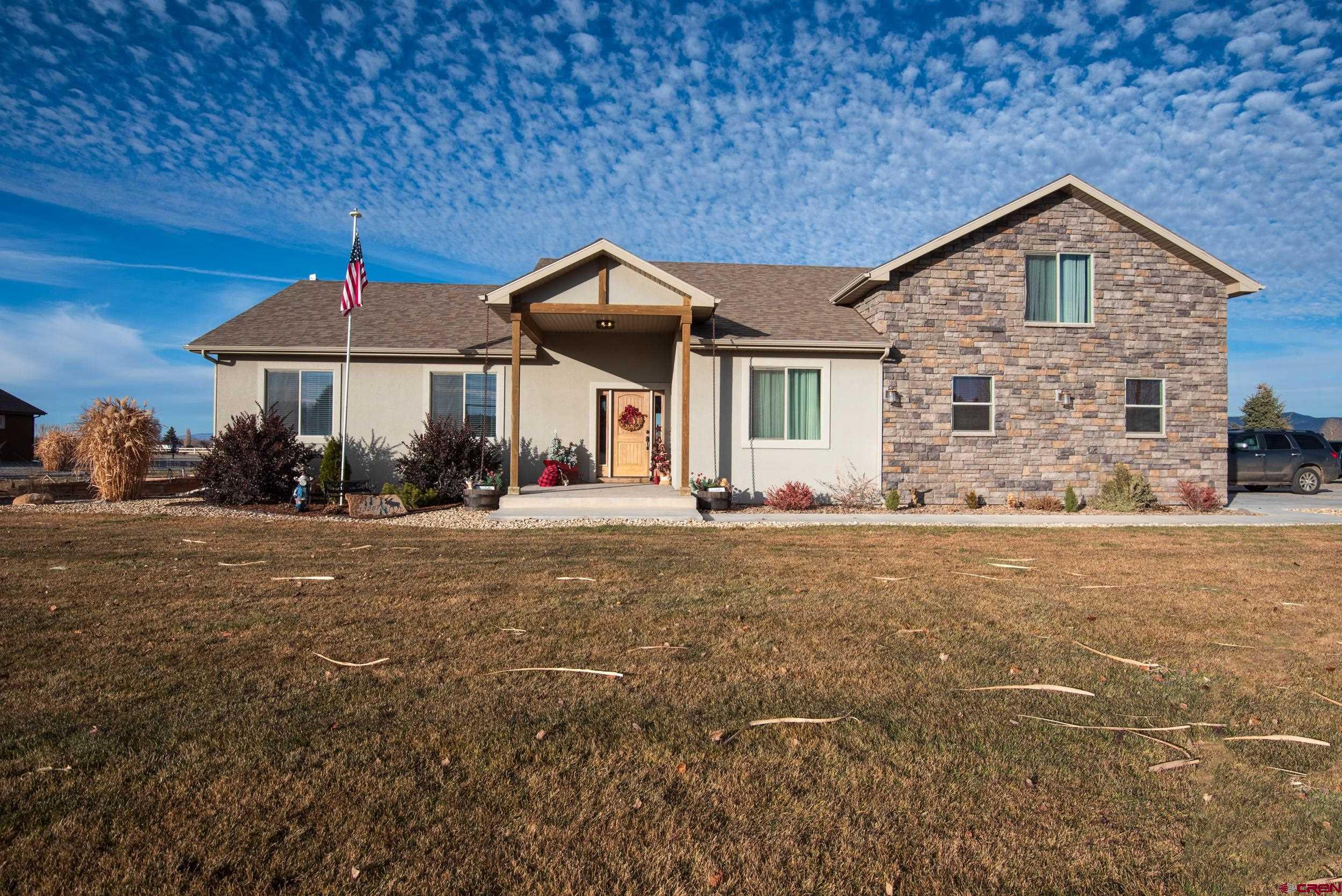 13287 6160th Road Montrose, CO 81403 - Photo 2 of 35 a front view of a house with a yard