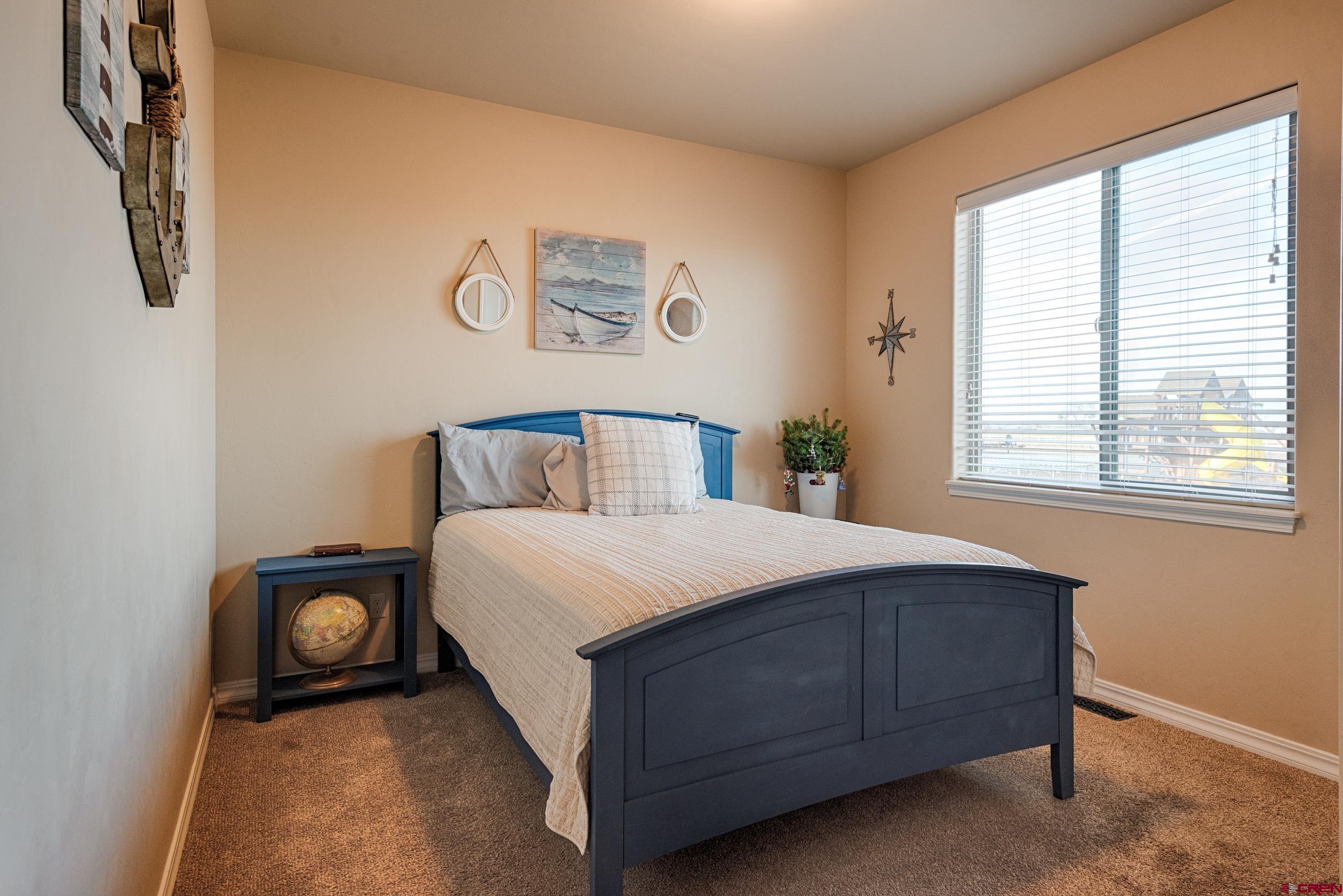 13287 6160th Road Montrose, CO 81403 - Photo 22 of 35 a bedroom with a bed and painting on the wall