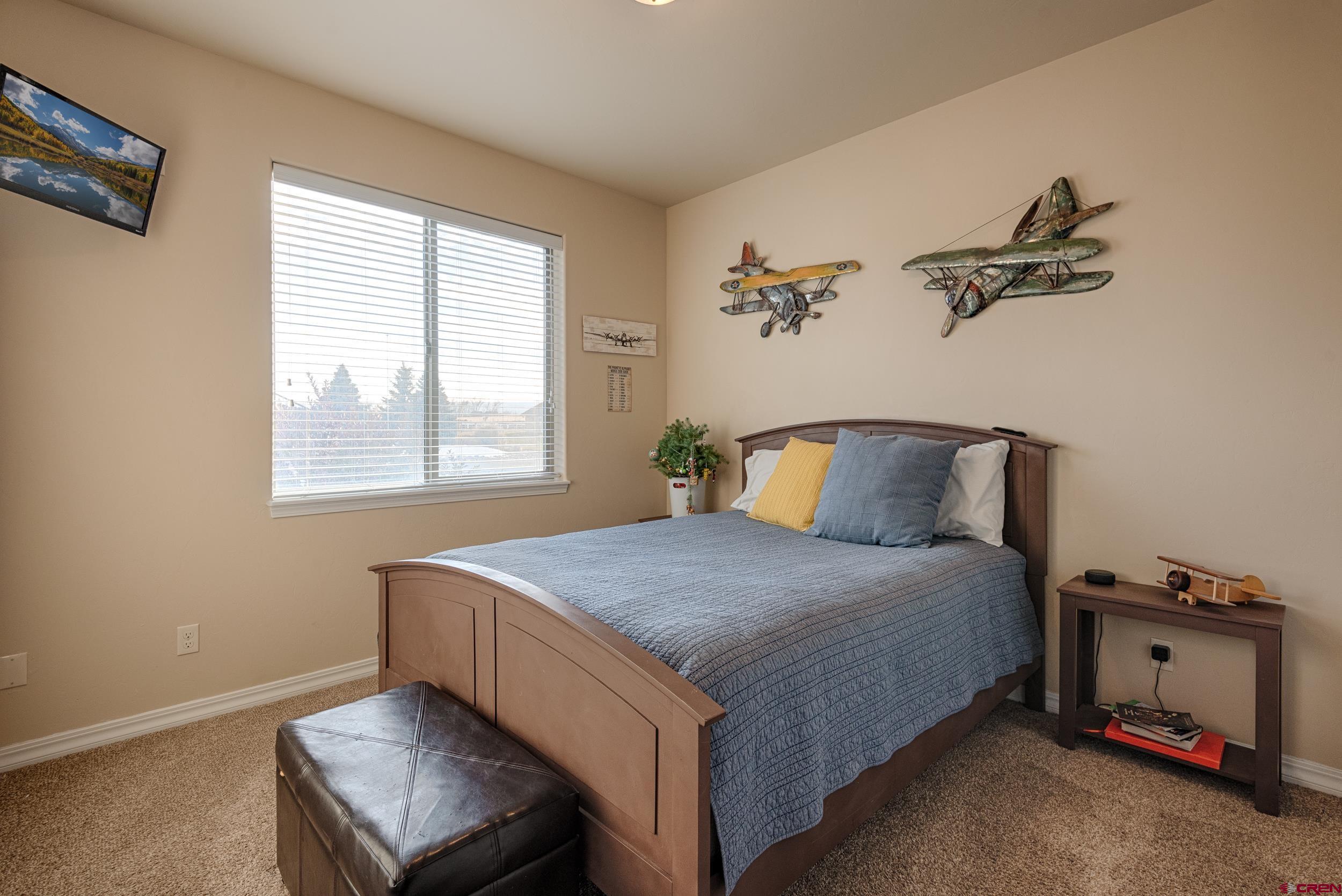 13287 6160th Road Montrose, CO 81403 - Photo 24 of 35 a bedroom with a bed and a window