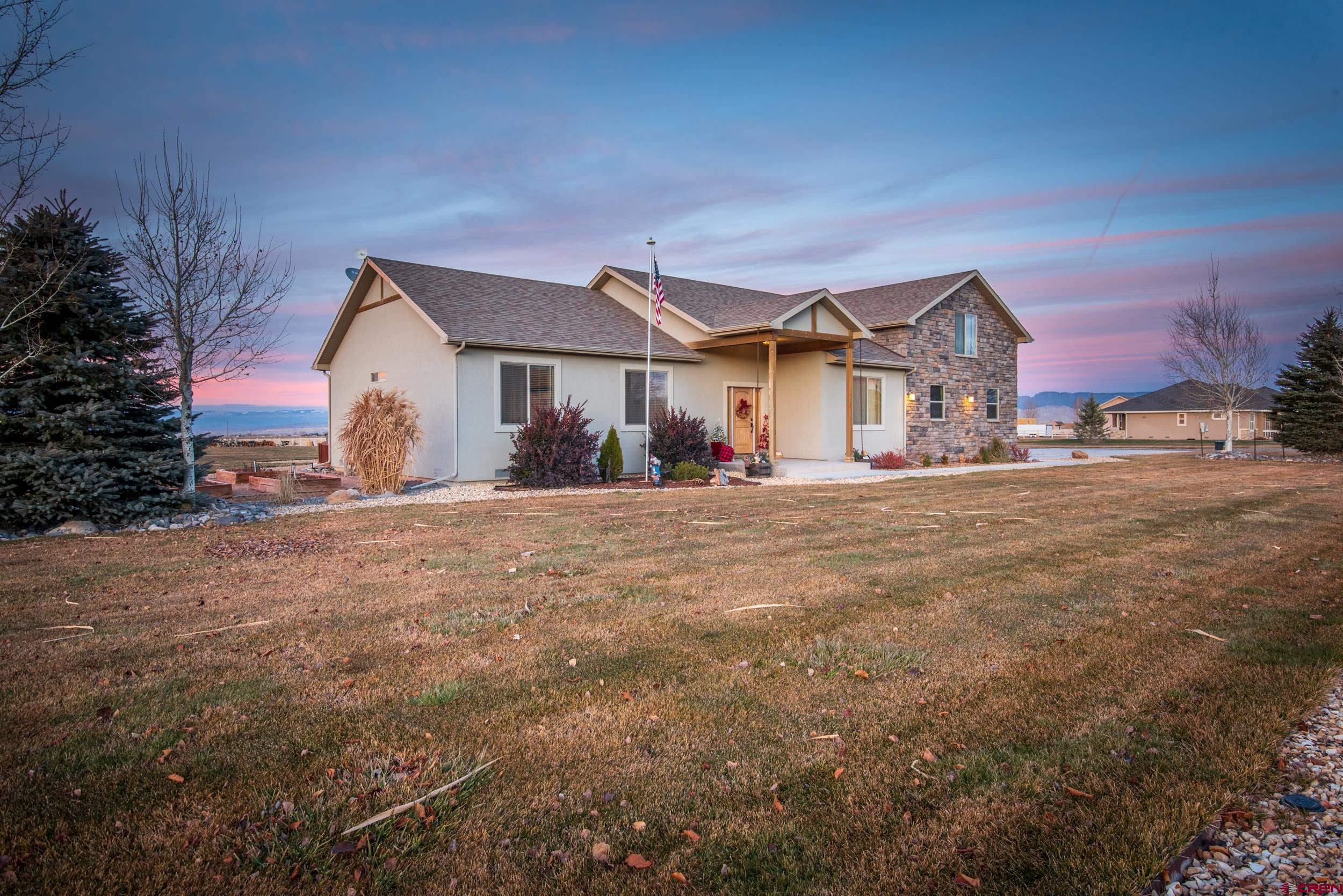 13287 6160th Road Montrose, CO 81403 - Photo 32 of 35 a front view of a house with a yard