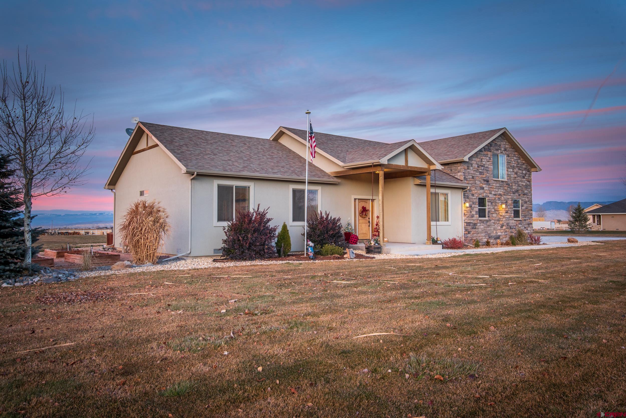 13287 6160th Road Montrose, CO 81403 - Photo 33 of 35 a front view of a house with a garden and yard