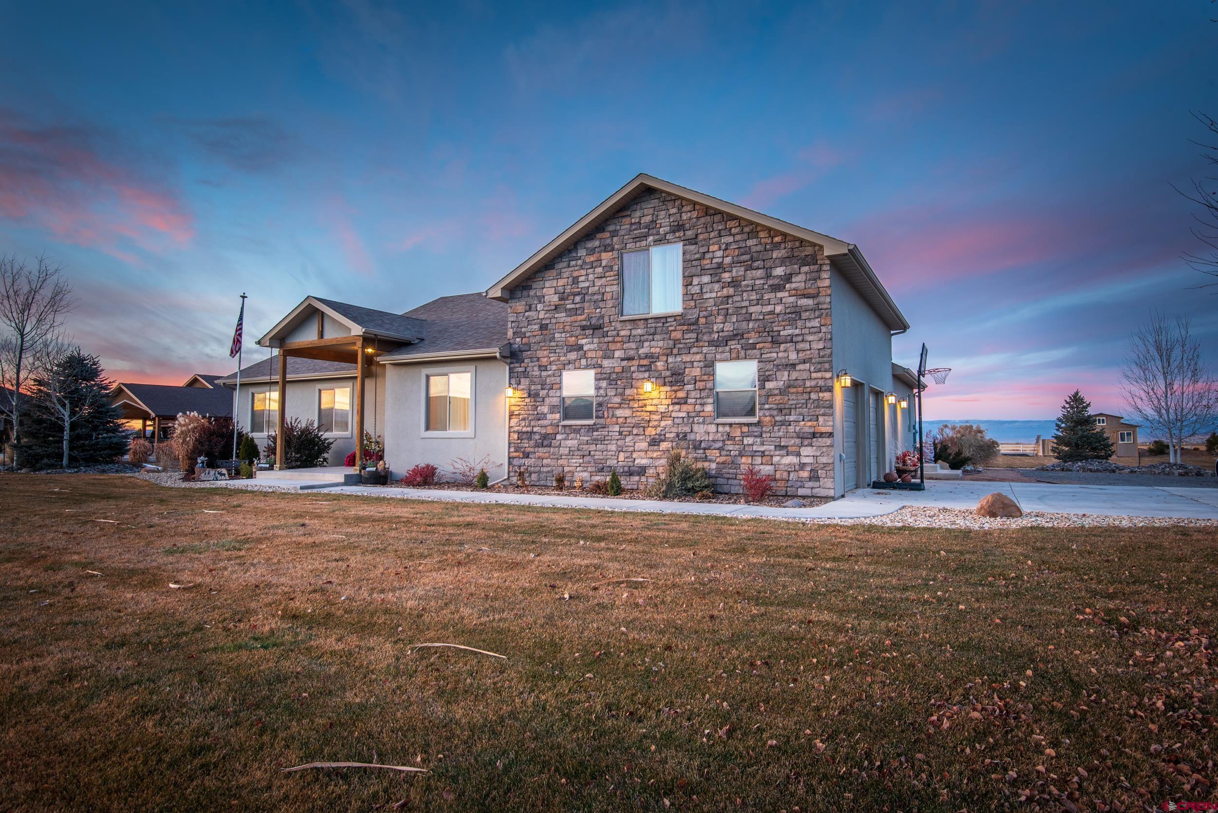 13287 6160th Road Montrose, CO 81403 - Photo 34 of 35 a front view of a house with a yard and garage