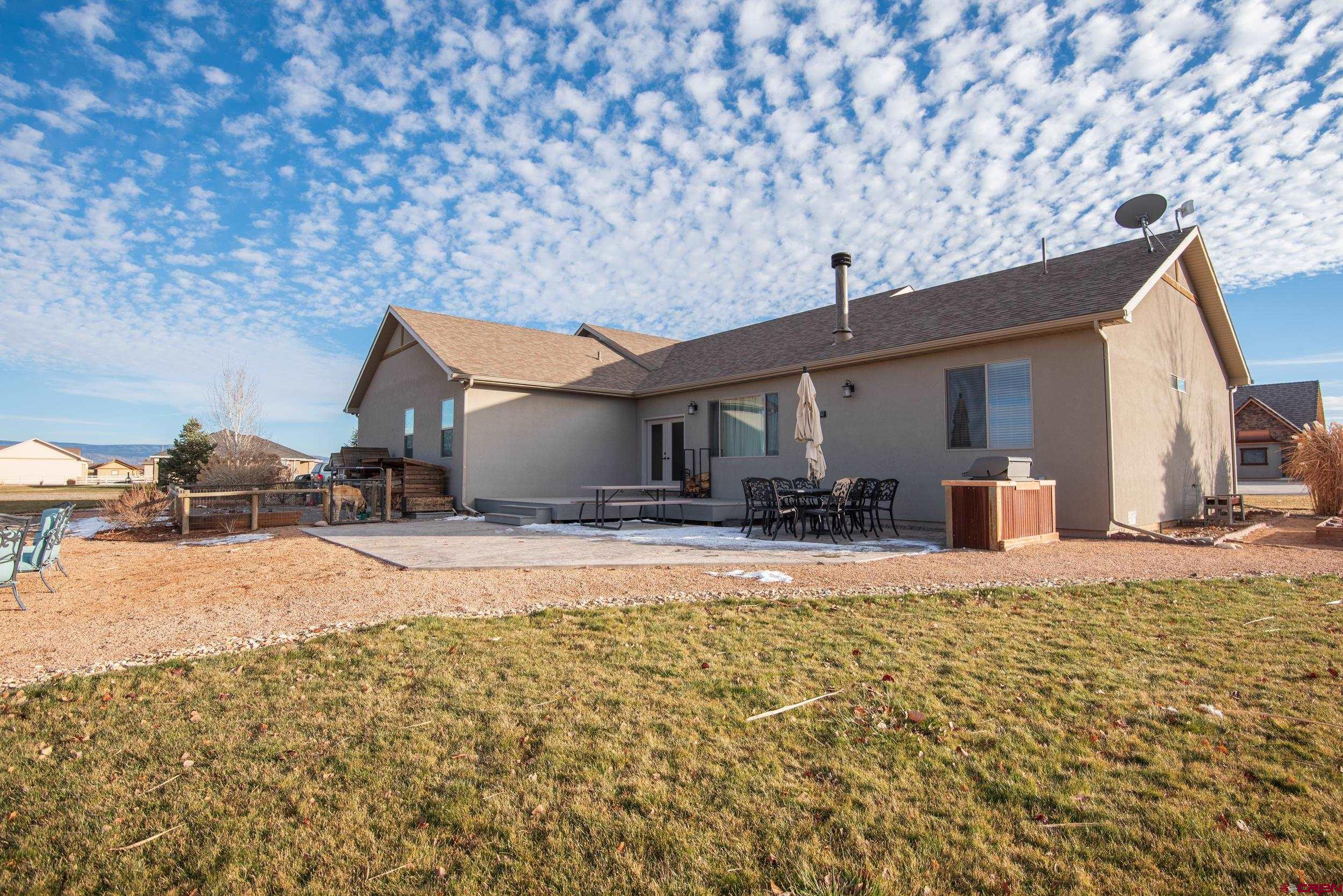 13287 6160th Road Montrose, CO 81403 - Photo 4 of 35 a front view of a house with a yard and garage