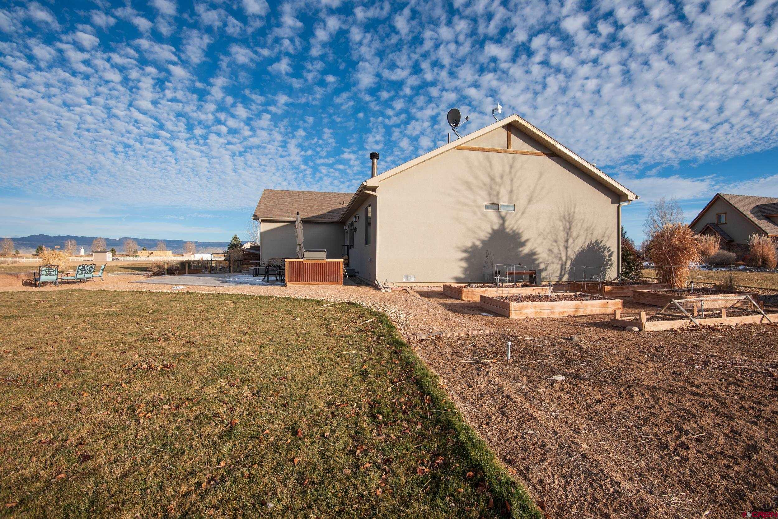 13287 6160th Road Montrose, CO 81403 - Photo 5 of 35 a view of a house with backyard and trees