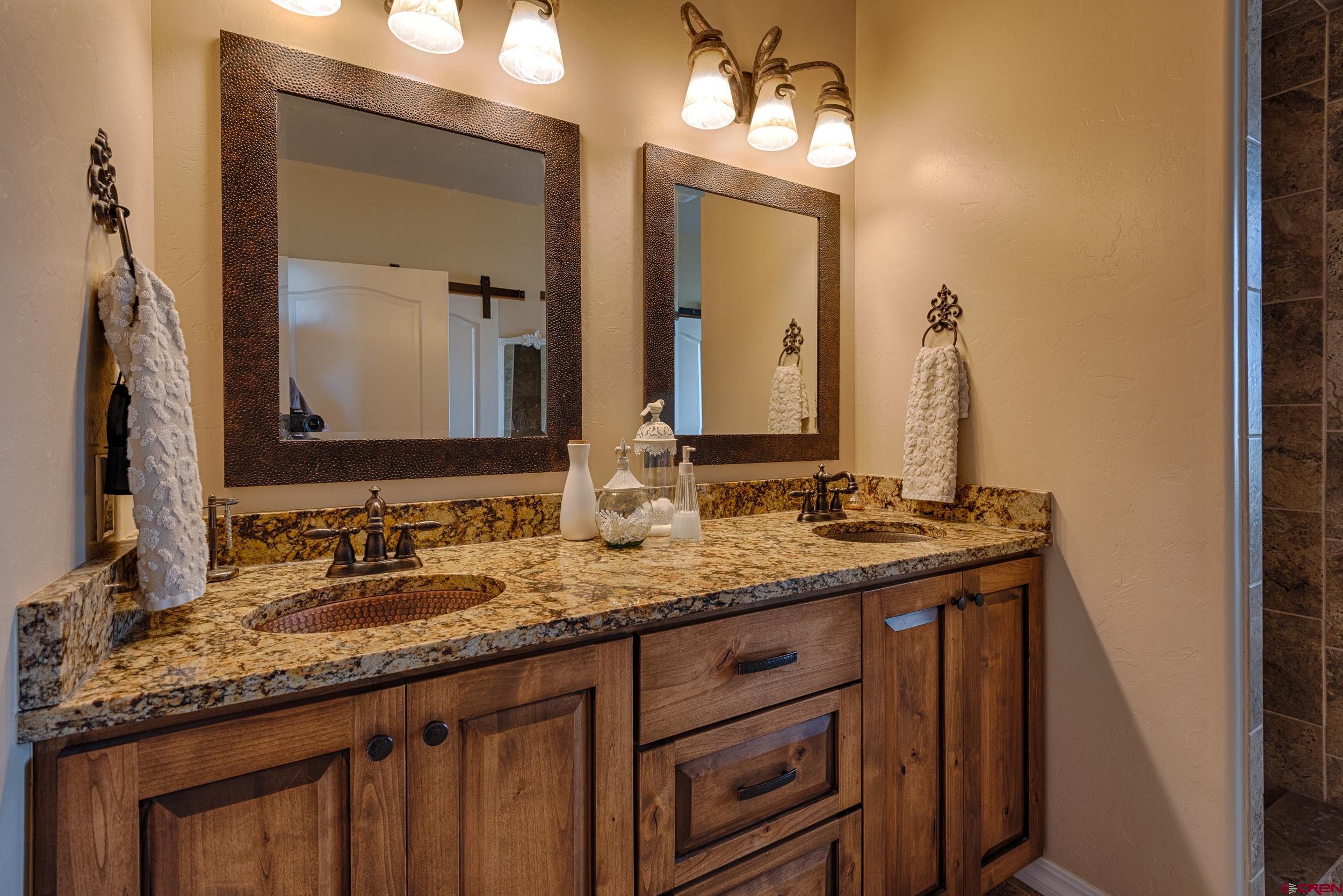 13287 6160th Road Montrose, CO 81403 - Photo 8 of 35 a bathroom with a granite countertop sink and a mirror