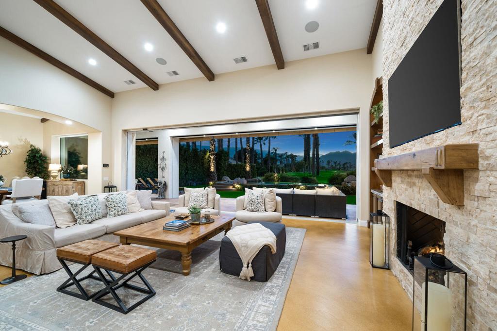 56495 Mountain La La Quinta, CA 92253 - Photo 25 of 56 a living room with fireplace furniture and a floor to ceiling window