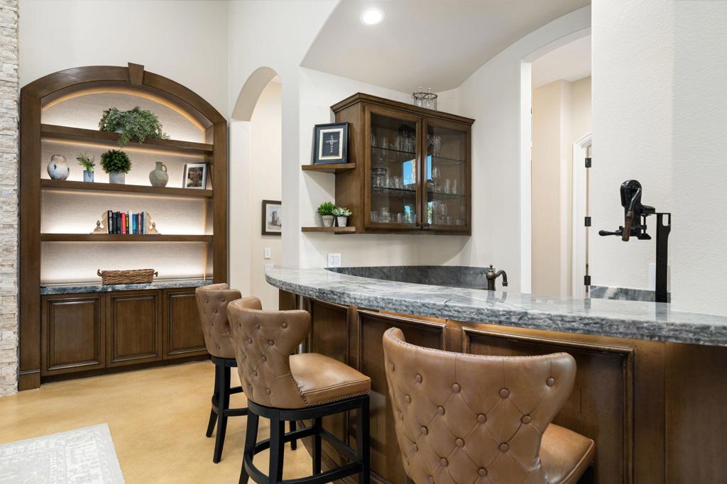 56495 Mountain La La Quinta, CA 92253 - Photo 29 of 56 a dining hall with granite countertop a dining table chairs and a large window