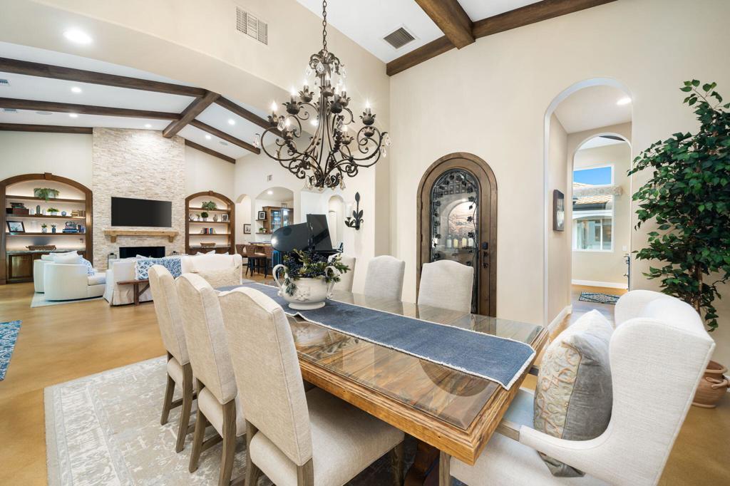 56495 Mountain La La Quinta, CA 92253 - Photo 30 of 56 a living room with furniture a chandelier and a dining table with wooden floor
